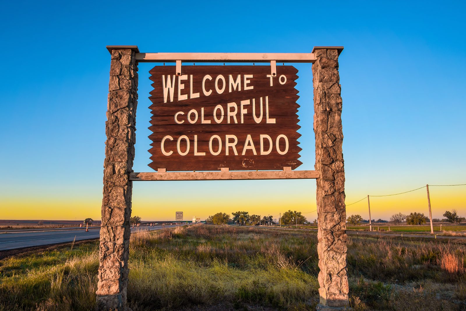 Wooden welcome sign at the Colorado state line
